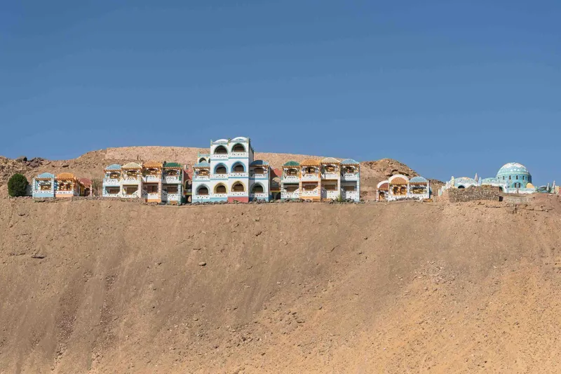 Buildings of the Nubian Village in Aswan on top of a sand ridge