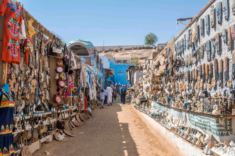 Extensive trinket kiosks covering the colorful walls and doors of the Nubian Village in Aswan